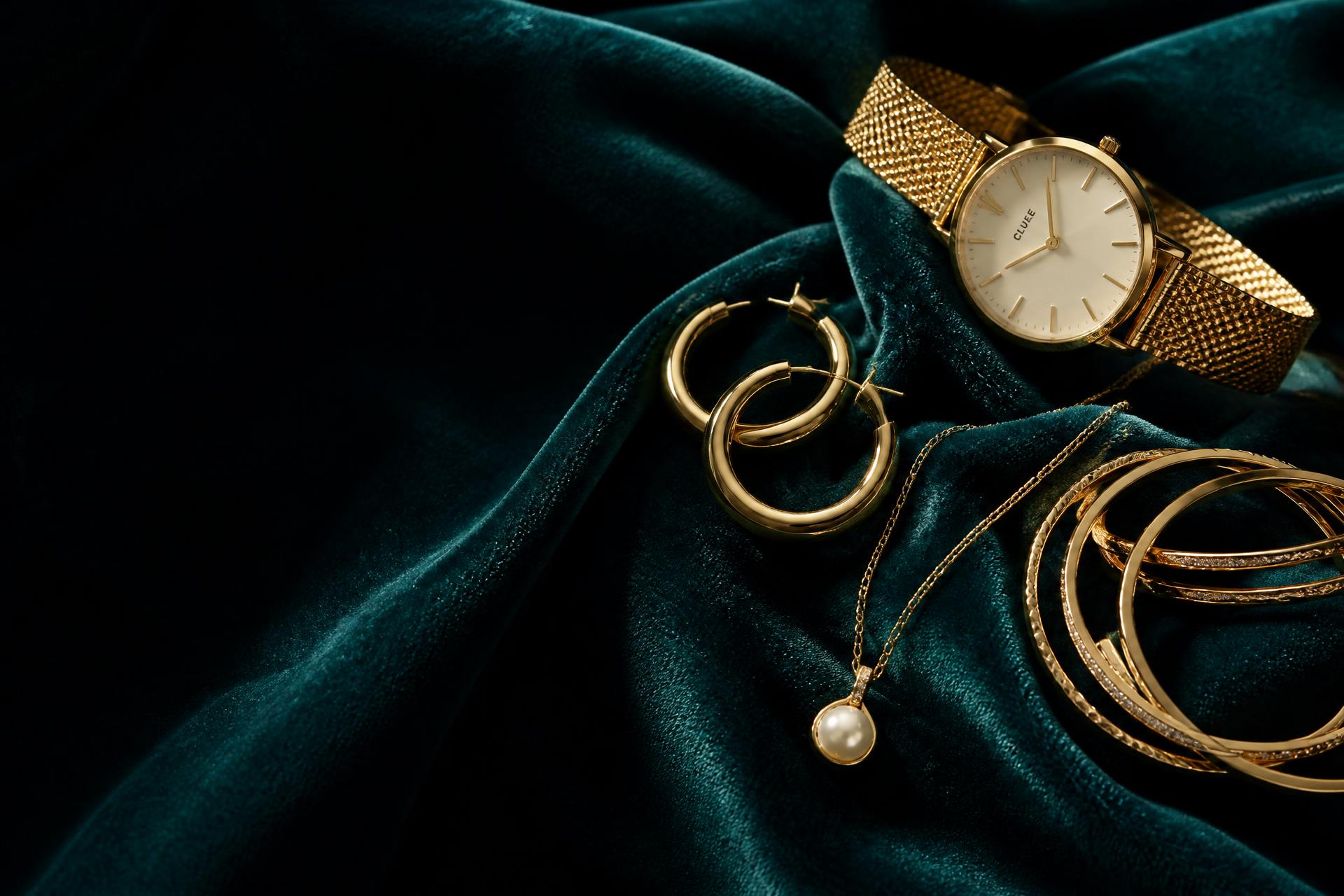 Gold jewellery on teal velvet